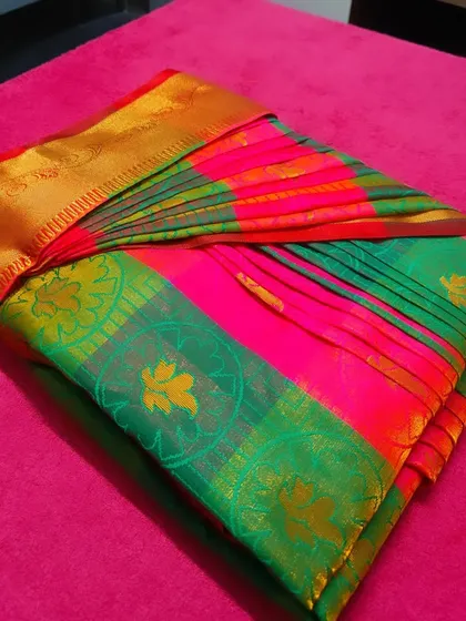 A close-up of the folded saree, showing the crisp pleats and the rich texture of the fabric. I handle every saree with the utmost care.