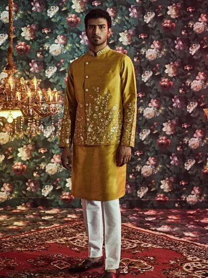 We design for every celebration, like this vibrant yellow silk outfit for a Haldi ceremony, detailed with delicate floral embroidery for a touch of festive grace.