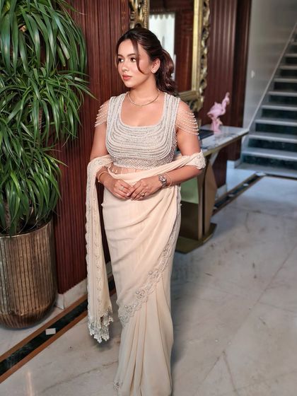 A full-length view of the elegant draped saree, perfect for a cocktail party or engagement.