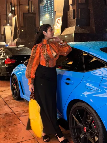 The full look next to the car. This outfit is a great example of a chic, city night-out look.