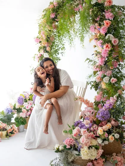 Pure, unfiltered joy! My Mother's Day mini-sessions are all about celebrating moms. Surrounded by flowers, this beautiful mother and daughter share a laugh that is absolutely infectious and heartwarming.