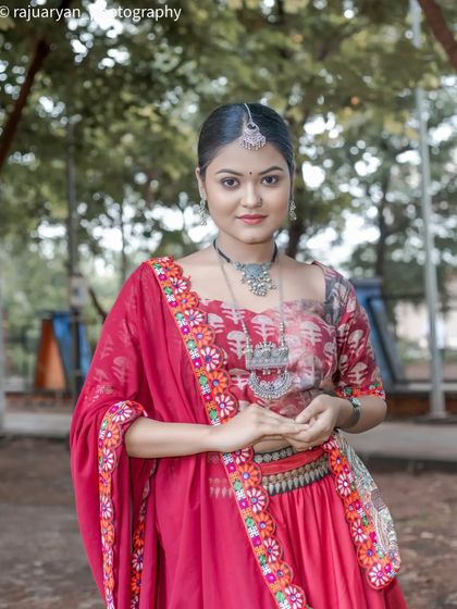 A close-up portrait focusing on the model's serene expression and the details of her embroidered dupatta and silver necklace. The soft background keeps the attention on her.