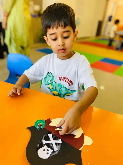 A student carefully works on his pirate craft, showing the detailed work that goes into our art projects.