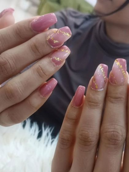 A lovely pink marble design accented with delicate gold foil flakes on coffin-shaped nails.