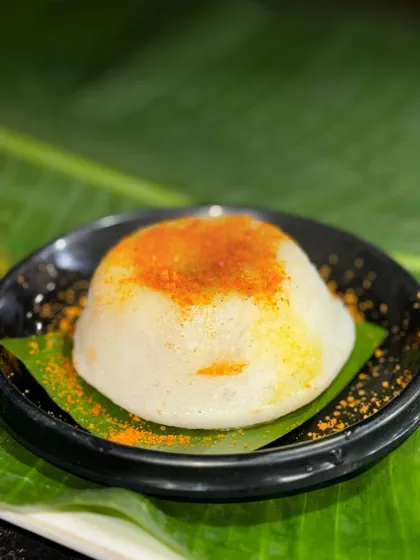 A close up of the Lava Idli, showing the soft texture and the spicy podi powder sprinkled on top. It's a simple yet elegant presentation that hints at the flavourful surprise inside.