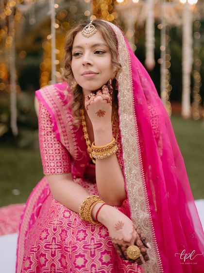 A thoughtful portrait of the bride. This shot highlights her natural curls and the soft, "barely there" makeup that enhances her features beautifully.