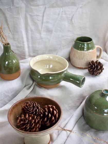 A collection of green and neutral-toned pieces made by my graduating students. The variety of forms and glazes is a testament to their hard work.