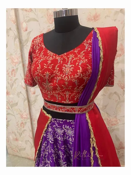 Another look at the red and purple half-saree, highlighting the custom-fit blouse and the elegant drape of the dupatta.
