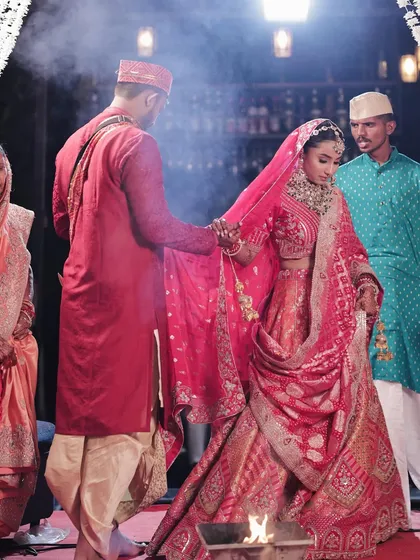 The bride and groom during the pheras. Her makeup is designed to be long-lasting and photogenic, ensuring she looks her best during the most important moments.