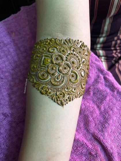 A close-up of the armband, featuring a beautiful and intricate 3D-style floral motif.