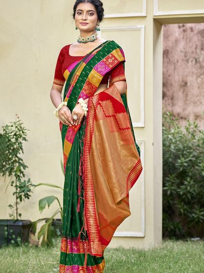 This bottle green Dupion silk saree is a classic beauty. The rich color and traditional border make it a perfect choice for any formal or festive occasion.