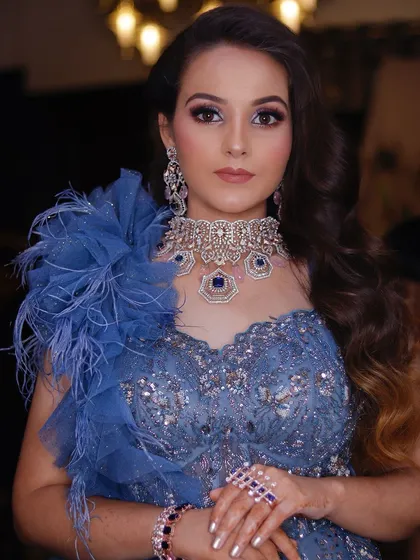 A portrait of my stunning bride in her blue cocktail gown. The makeup features a dramatic eye and glowing skin.