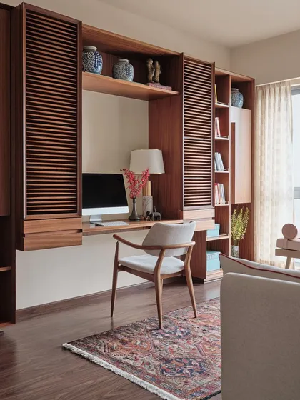 A study should be both functional and inspiring. For this apartment, I designed a floating desk and shelving unit with louvered shutters and open niches, providing ample storage while maintaining a sense of lightness. The space is finished with a classic Persian rug for warmth and character.