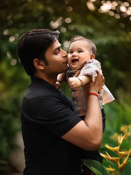 A lifetime of love in a single kiss. This tender moment between a father and his laughing baby is a perfect example of the candid shots I love to capture outdoors.