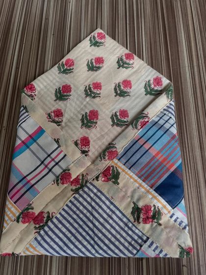 The back of the crazy patchwork envelope pouch, showing how different scraps of fabric are pieced together. This is a creative way to use up every last bit of material.