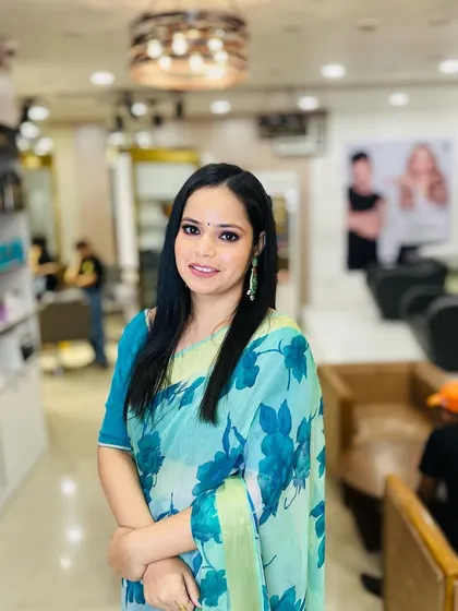This client looks fresh and radiant in her light blue floral saree. The makeup is kept light and natural to match the daytime feel.