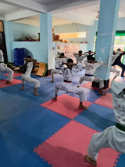 Students holding a deep horse riding stance ('Juchum Seogi') to build strength and stability.