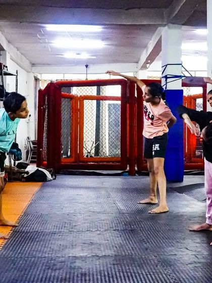 Kids practicing their warm-up stretches together. Flexibility and mobility are just as important as strength, and I make sure to incorporate them into every kids' session.