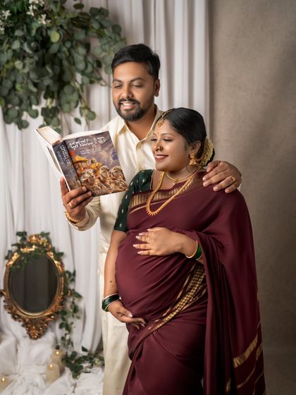 Sharing stories and traditions with the little one even before they arrive. This pose, with the dad-to-be reading to the baby bump, is a beautiful way to document their bond.