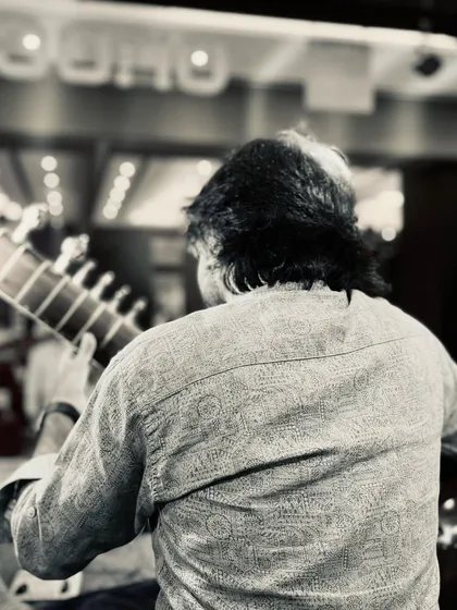A black and white photo from behind, capturing the atmosphere of a live performance.