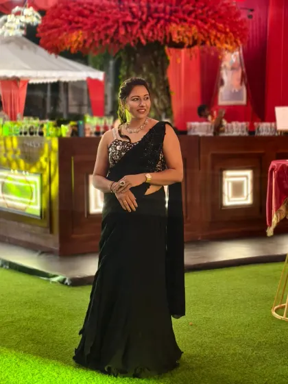 A powerful pose in a classic black saree for a Sangeet night. The right outfit helps me channel the confident 'power host' energy needed for a big celebration.