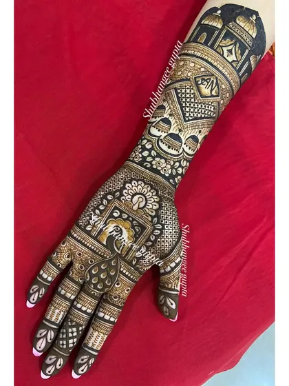This design was created on demand for a client who wanted a mix of modern and traditional. It includes a peacock on the palm, geometric patterns, and personalized initials hidden within the design.