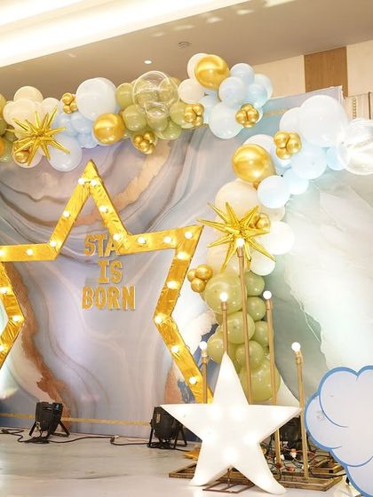 Another angle of the naming ceremony setup, highlighting the crescent moon prop and the beautiful balance of the balloon arches.