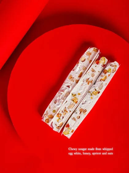 Our Nougat is made from whipped egg whites, honey, apricot, and nuts, a classic Franco-Italian Christmas treat.