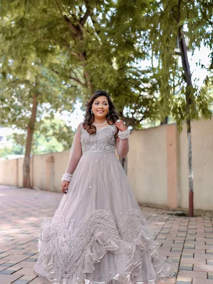 A full-length shot of the bride's shimmering silver reception gown. The entire look is glamorous and ready for a night of celebration.