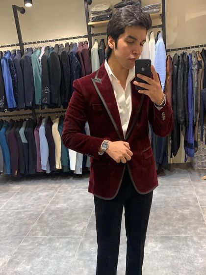 Another angle of the maroon velvet blazer, showing its tailored fit. This is a great option for a groom's reception or a formal party.