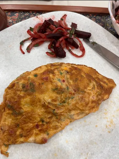 A fluffy vegetable omelette with a side of beetroot salad. A great low-carb, high-protein breakfast to start the day.