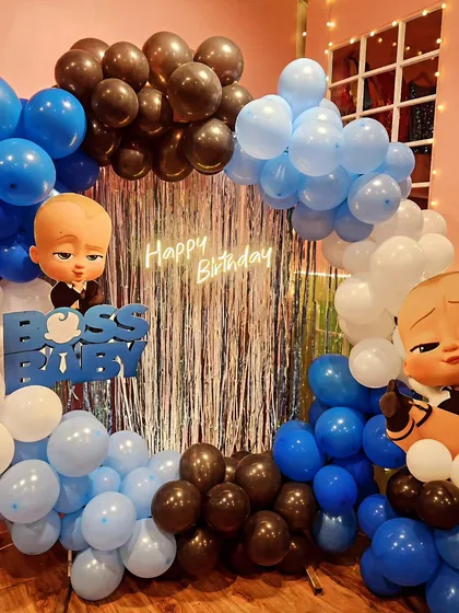 Time to party like a boss! This Boss Baby theme features character cutouts and a stylish blue, black, and white balloon arch for a cool and fun celebration.