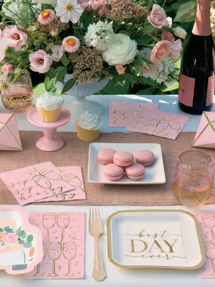 Every celebration deserves a table that tells a story. This 'Best Day Ever' setup features chic pink and gold tableware, macarons, and cupcakes for a perfect bridal shower or birthday brunch.
