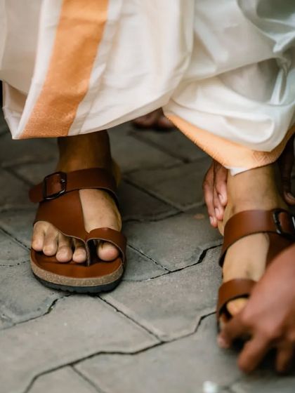 Capturing the details, right down to the groom's traditional footwear, which is an important part of the wedding attire.