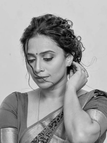 A series of studio portraits featuring a model in a black and red printed saree. The images range from expressive close-ups to elegant full-body shots, demonstrating versatile studio lighting.