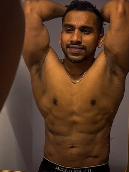 A mirror check showing abdominal and chest definition. Staying lean requires a consistent and clean diet, which is a critical component of my contest prep programs.