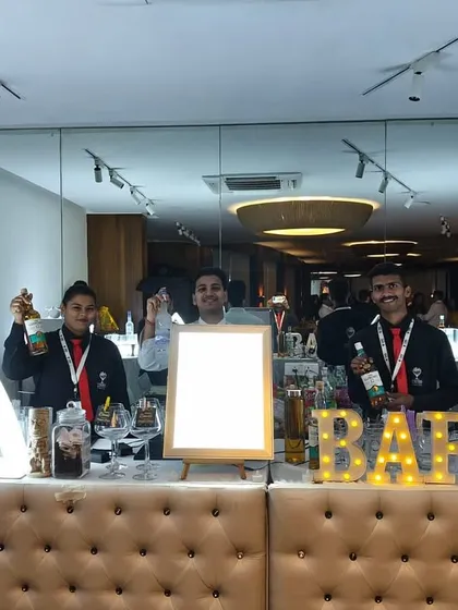 Our team proudly presenting our tufted bar with illuminated 'BAR' sign and triangular LED displays. This setup is clean, professional, and fully customizable.