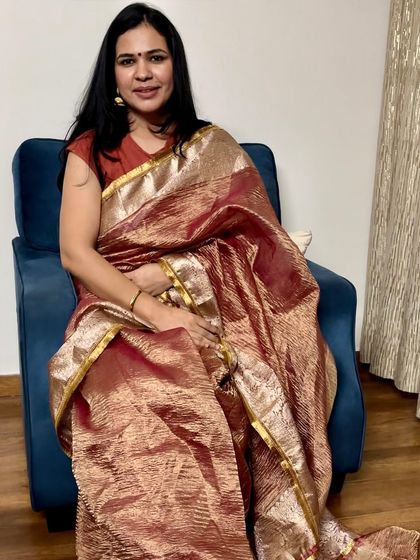 A beautiful maroon and gold tissue saree. The rich texture and color make it perfect for winter festivities or evening events.
