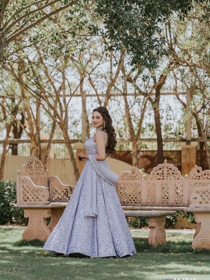 A stunning shot of the bride in a garden, her hair and outfit looking like they belong in a fairytale.