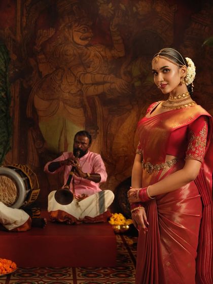 A closer look at the elegant drape on this red silk saree for a Pothys campaign. The pleats are kept sharp and the pallu is styled to create a regal look.