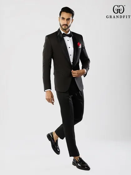A full view of our classic tuxedo, showcasing a flawless drape and silhouette. Tailored to perfection, this garment combines traditional elegance with a modern sensibility for the discerning gentleman.