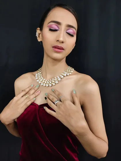 A serene pose that showcases the beautiful blend of colors in the eye makeup. This look is both bold and romantic.