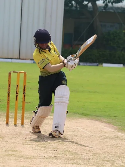 A female batter plays a textbook drive, demonstrating the strong technical foundation we build in our players.