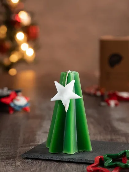 A more modern, minimalist take on the Christmas tree candle, this one has a geometric shape and is adorned with a simple white star.