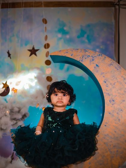 A different take on our celestial moon theme. This image shows how a darker, more formal dress can create a dramatic and elegant look against the dreamy backdrop.