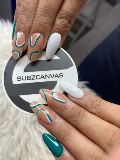 This abstract line art set uses a nude base to highlight the flowing teal and white lines. The solid accent nails in teal and white complete this cohesive, artistic manicure.