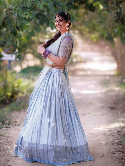 A joyful, swirling pose that shows off the beautiful movement of the lehenga. This shot is full of life, happiness, and graceful energy.
