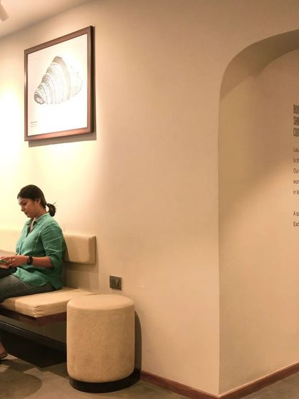 A comfortable seating nook at Subko Coffee, perfect for enjoying a quiet moment. The neutral tones and soft upholstery create a relaxing ambiance.