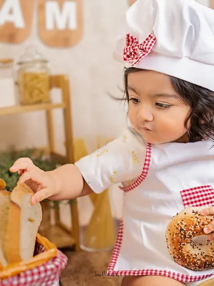 A bagel and a slice of bread, the perfect snack for a busy little baker. The details in this chef-themed setup create a rich, story-telling image.
