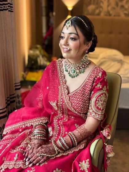 Seated by the window, the bride looks absolutely stunning. The natural light highlights the flawless base and the soft glam makeup that enhances her features.